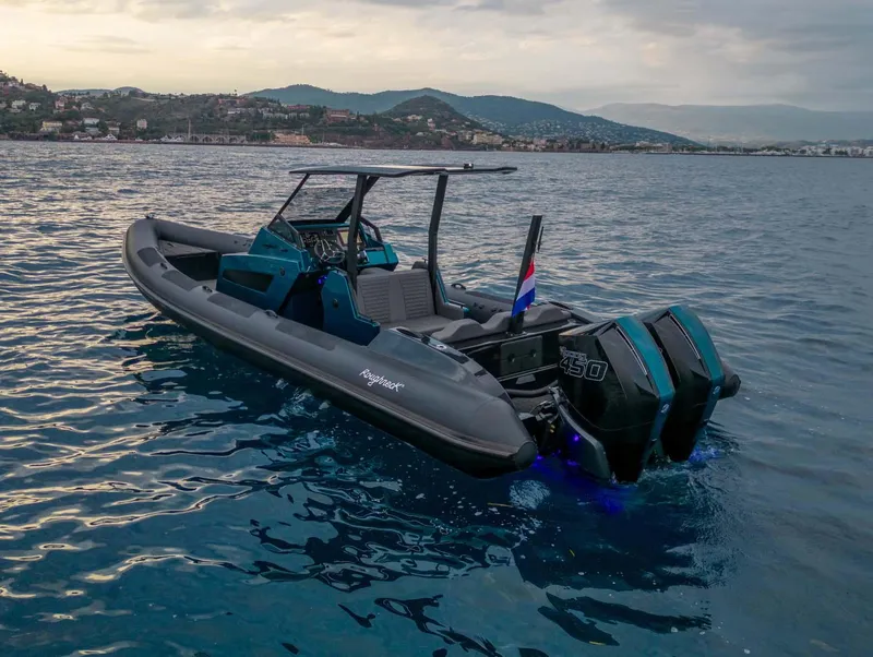 Slide: The Image of 2023 Roughneck 36 T Top boat on calm water, featuring dual outboard engines. - 47