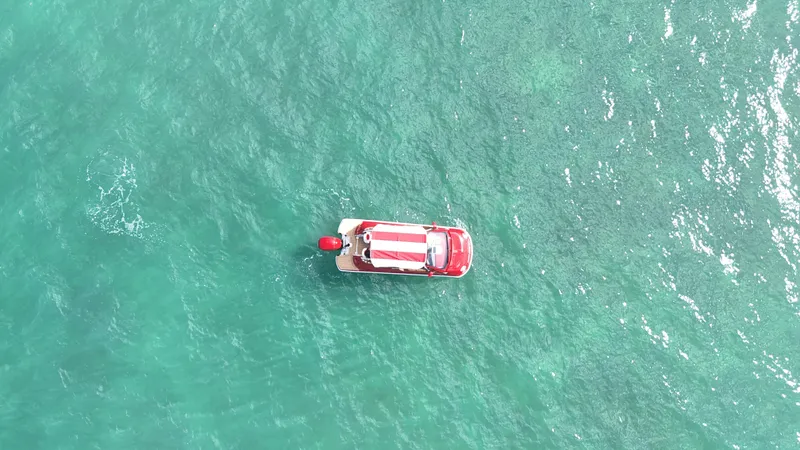 Slide: The Image of Aerial view of 2025 Car Off-shore Fiat 500 Classic on turquoise water. - 3