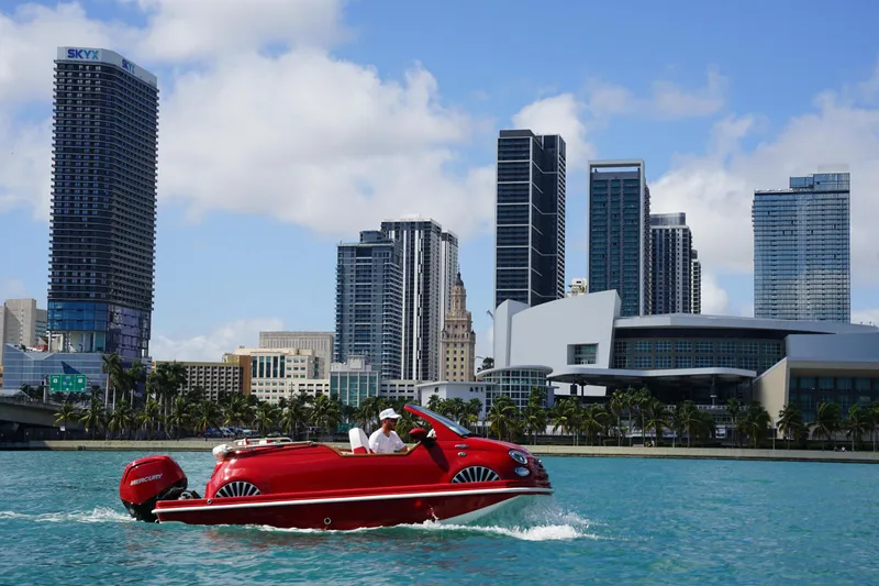Slide: The Image of Amphibious Fiat 500 Classic boat cruising in city waters, 2025 model. - 8