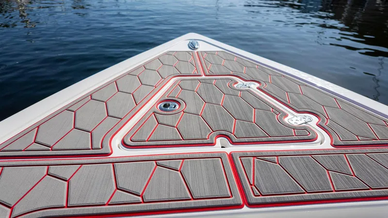 Slide: The Image of 2023 Fountain 38 SC boat deck with geometric pattern on calm water. - 11
