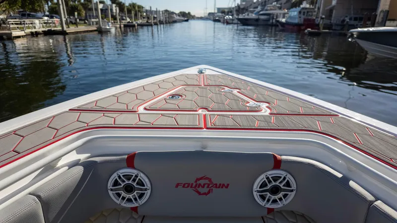 Slide: The Image of 2023 Fountain 38 SC boat bow with stylish deck design on a calm waterway. - 12