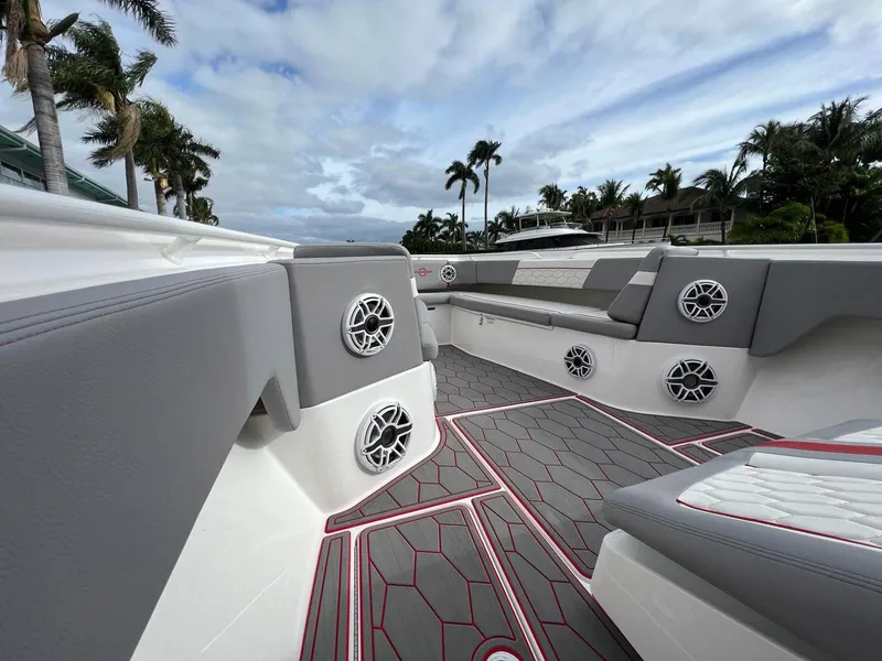 Slide: The Image of 2023 Fountain 38 SC boat interior with gray seating and modern speaker system. - 18