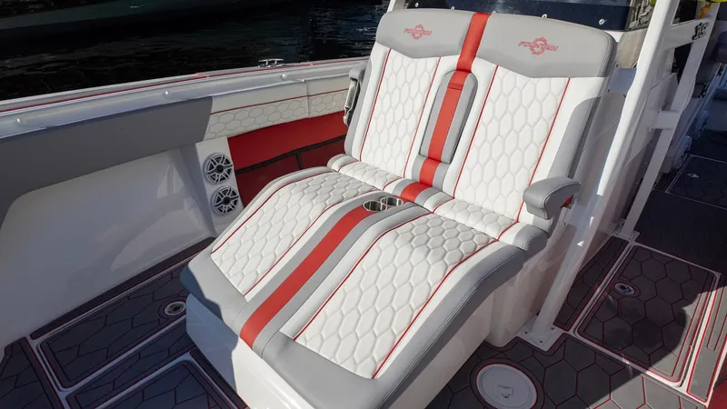 Slide: The Image of 2023 Fountain 38 SC boat seats with red accents and hexagonal pattern. - 23