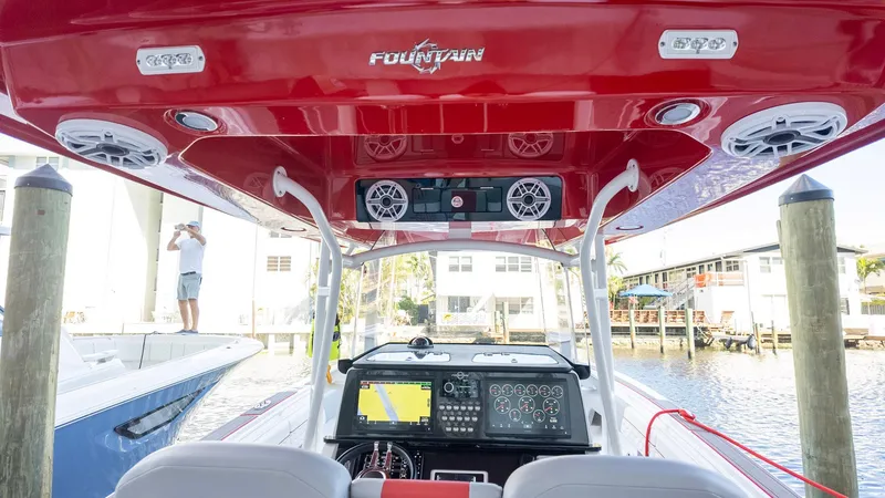 Slide: The Image of 2023 Fountain 38 SC boat interior with red canopy and advanced navigation system. - 25