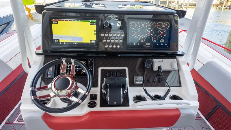 Slide: The Image of Control panel of 2023 Fountain 38 SC boat with advanced navigation and steering features. - 26