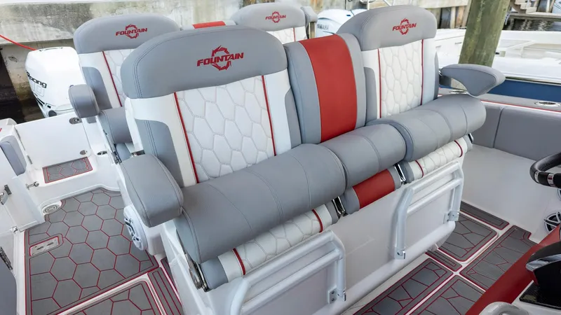 Slide: The Image of 2023 Fountain 38 SC boat seats with gray and red accents, featuring hexagonal patterns. - 30