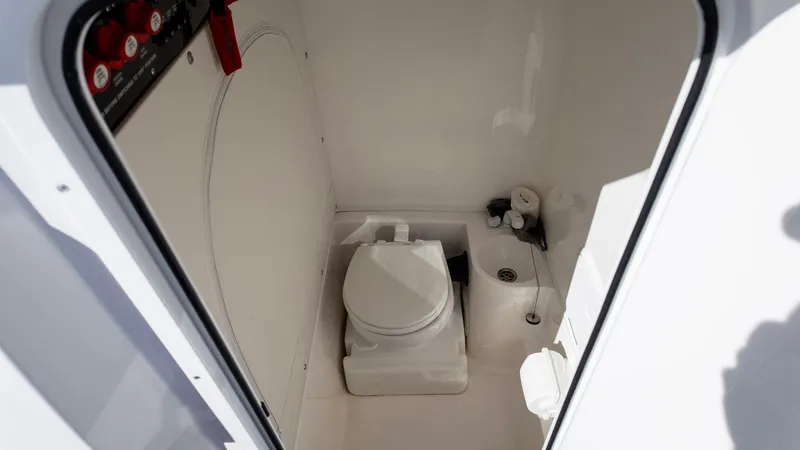 Slide: The Image of 2023 Fountain 38 SC boat interior bathroom with toilet and sink. - 36