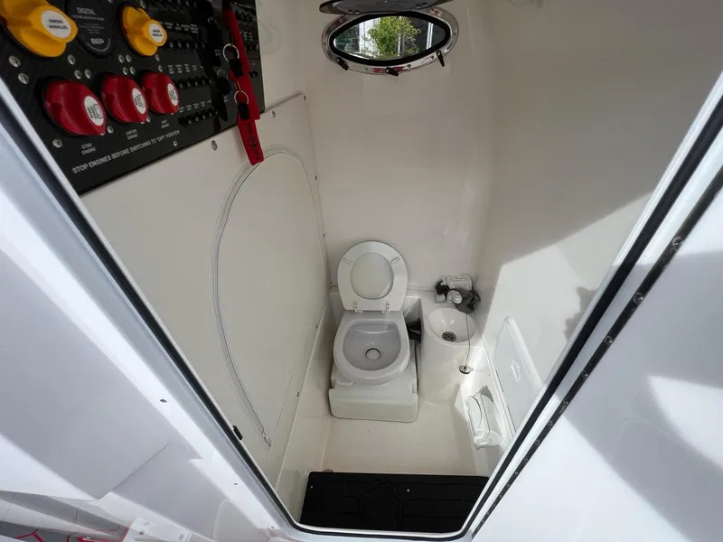 Slide: The Image of 2023 Fountain 38 SC boat interior bathroom with toilet and control panel. - 37