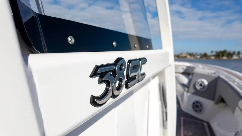 Slide: The Image of 2023 Fountain 38 SC boat detail with logo, docked under a clear sky. - 41