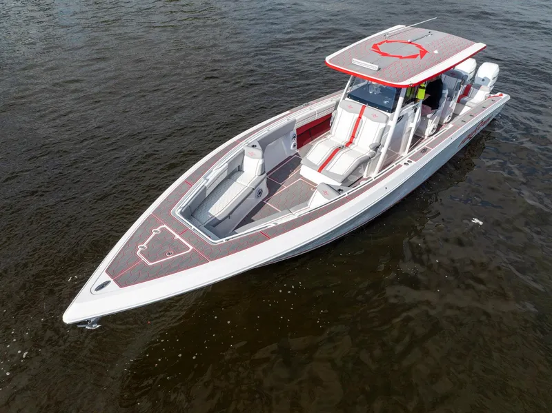 Slide: The Image of 2023 Fountain 38 SC boat on water, sleek design, red accents, spacious deck. - 5