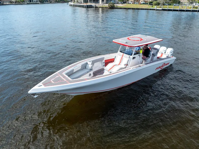 Slide: The Image of 2023 Fountain 38 SC boat on calm water, featuring sleek design and modern amenities. - 6