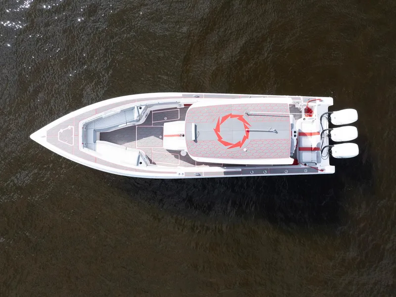 Slide: The Image of Aerial view of 2023 Fountain 38 SC boat with triple engines on dark water. - 7