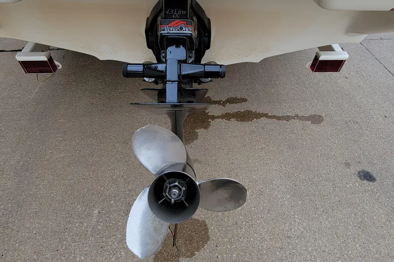 Slide: The Image of 1994 Sea Ray 180 Bow Rider boat propeller and Alpha One outdrive on concrete surface. - 11