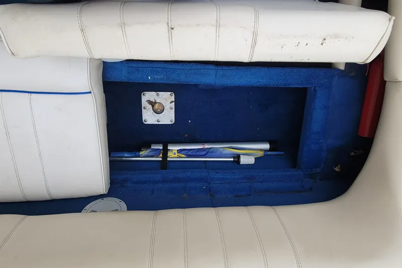 Slide: The Image of 1994 Sea Ray 180 Bow Rider interior with blue carpet and white seating. - 17