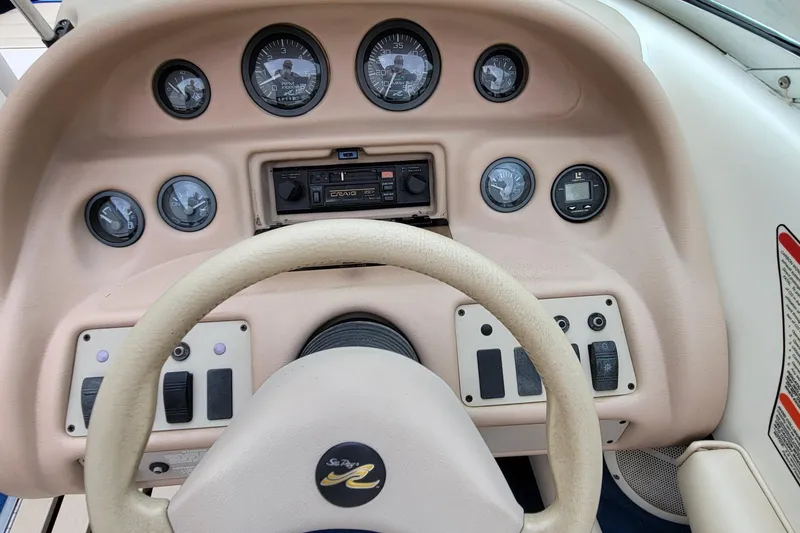 Slide: The Image of 1994 Sea Ray 180 Bow Rider dashboard with gauges and steering wheel. - 19