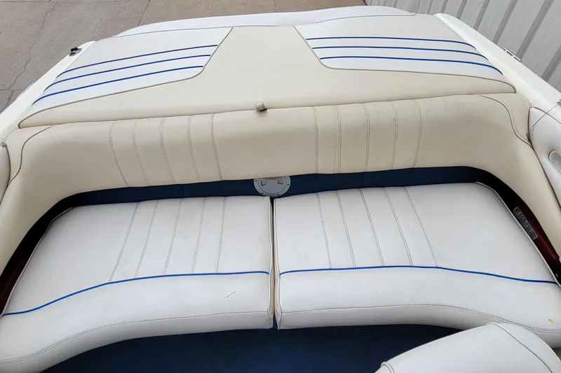 Slide: The Image of 1994 Sea Ray 180 Bow Rider interior with white and blue cushioned seating. - 21