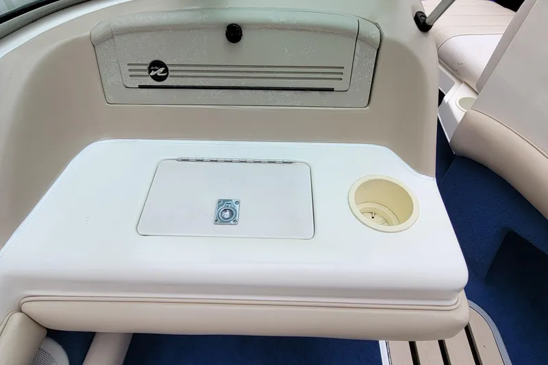 Slide: The Image of 1994 Sea Ray 180 Bow Rider interior with storage compartment and cup holder. - 27