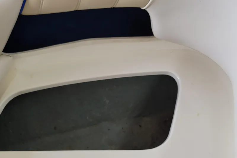 Slide: The Image of Interior view of a 1994 Sea Ray 180 Bow Rider boat seat and storage area. - 30