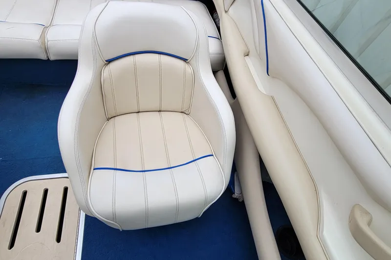 Slide: The Image of 1994 Sea Ray 180 Bow Rider interior with white and blue-trimmed seating. - 33