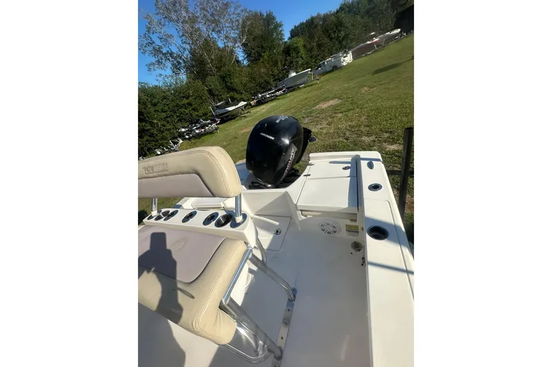 Slide: The Image of Pathfinder 2005 TRS boat, 2023 model, parked on grass with trees in background. - 14