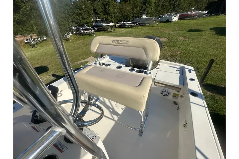 Slide: The Image of Pathfinder 2005 TRS boat interior with seating and rod holders, parked on grass. - 15