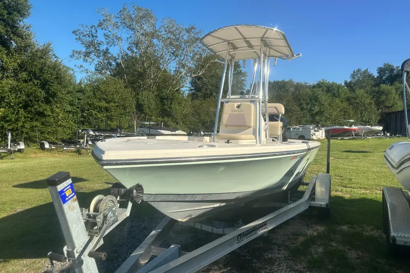 Slide: The Image of Pathfinder 2005 TRS boat on trailer, parked on grassy area, sunny day. - 6