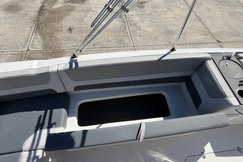 Slide: The Image of 2026 Starcraft SVX 211 OB boat interior with seating and storage compartment. - 12