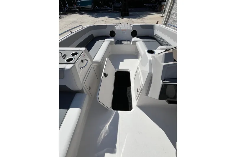 Slide: The Image of 2026 Starcraft SVX 211 OB boat interior with open storage compartment and seating. - 16