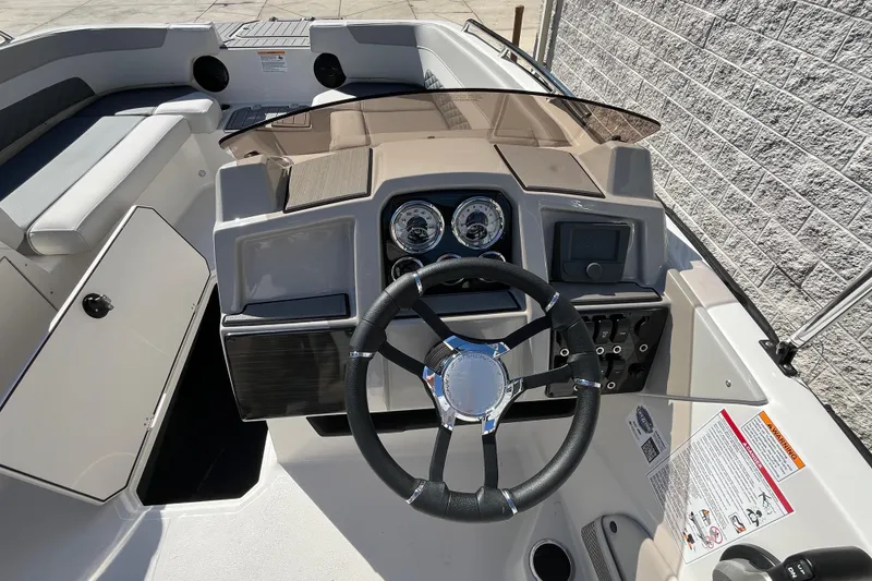 Slide: The Image of 2026 Starcraft SVX 211 OB boat dashboard with steering wheel and controls. - 17