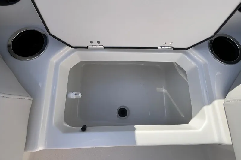 Slide: The Image of Starcraft SVX 211 OB 2026 boat interior storage compartment with cup holders. - 21