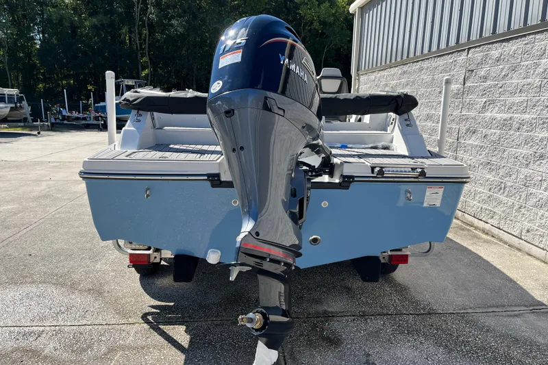 Slide: The Image of 2026 Starcraft SVX 211 OB boat with Yamaha outboard motor, parked outdoors. - 4