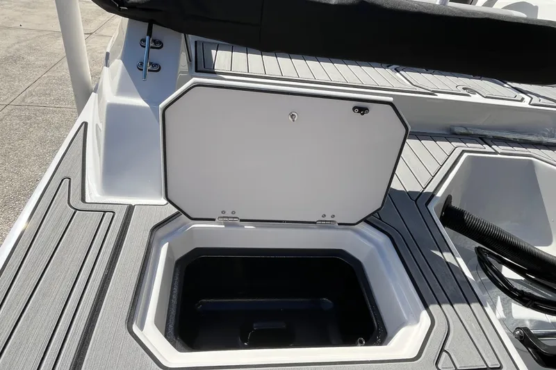 Slide: The Image of 2026 Starcraft SVX 211 OB boat storage compartment with open hatch on deck. - 9
