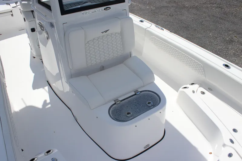 Slide: The Image of 2026 Tidewater 2700 Carolina Bay boat interior with white seating and storage compartment. - 10