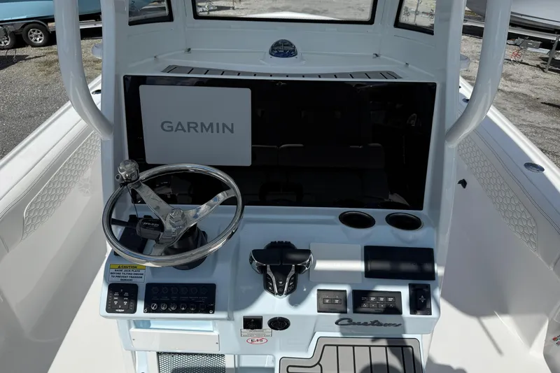 Slide: The Image of 2026 Tidewater 2700 Carolina Bay boat console with Garmin navigation system and steering wheel. - 13