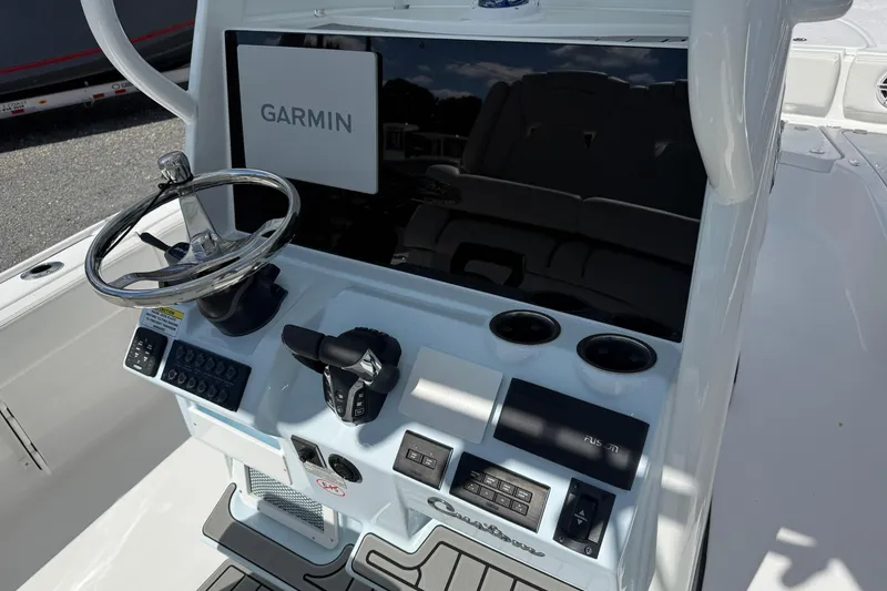 Slide: The Image of 2026 Tidewater 2700 Carolina Bay boat console with Garmin display and steering wheel. - 15