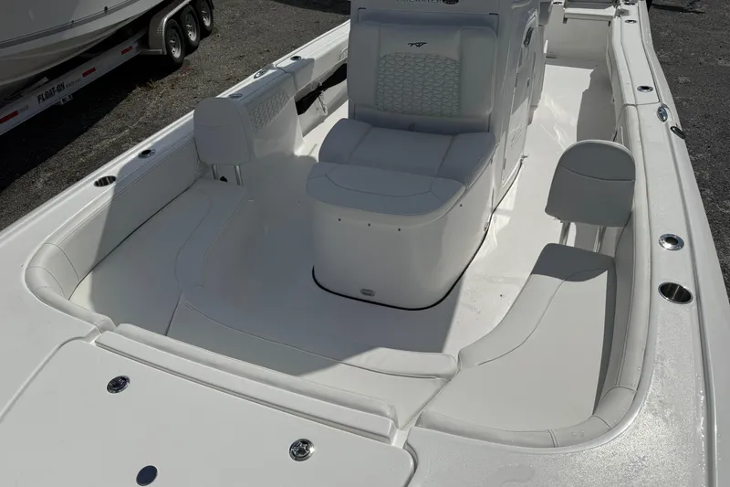 Slide: The Image of 2026 Tidewater 2700 Carolina Bay boat interior with white seating and console. - 17