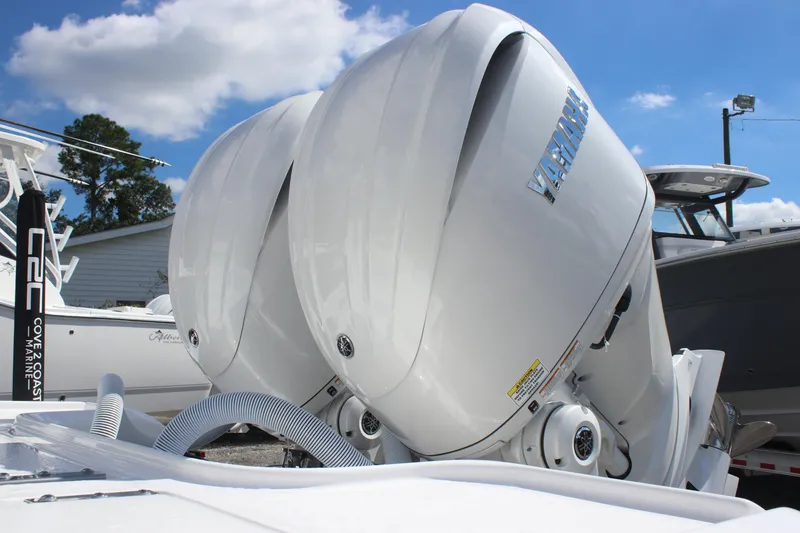 Slide: The Image of Twin Yamaha outboard engines on a 2026 Tidewater 2700 Carolina Bay boat under a clear sky. - 7