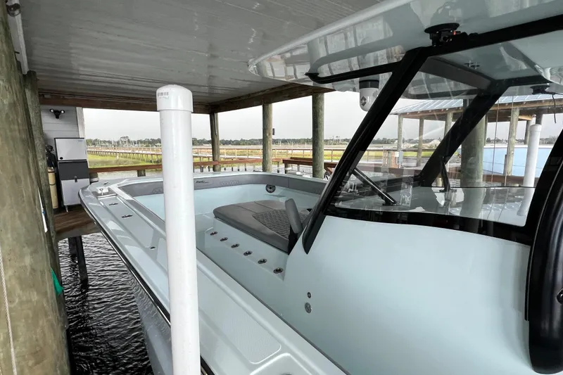 Slide: The Image of 2025 Front Runner 37 Catamaran docked under a covered pier, showcasing sleek design. - 11