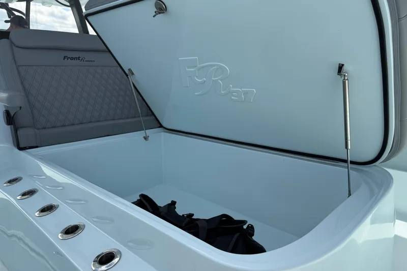 Slide: The Image of 2025 Front Runner 37 Catamaran storage compartment with open lid and seating. - 15