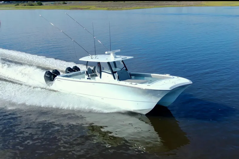 Slide: The Image of 2025 Front Runner 37 Catamaran cruising on calm water, showcasing sleek design and powerful engines. - 2