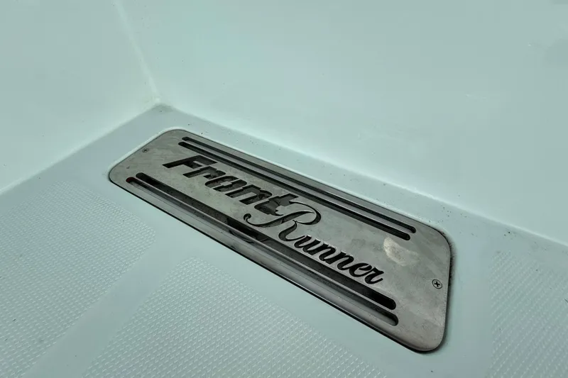 Slide: The Image of Front Runner 37 Catamaran 2025 logo on sleek boat surface. - 25