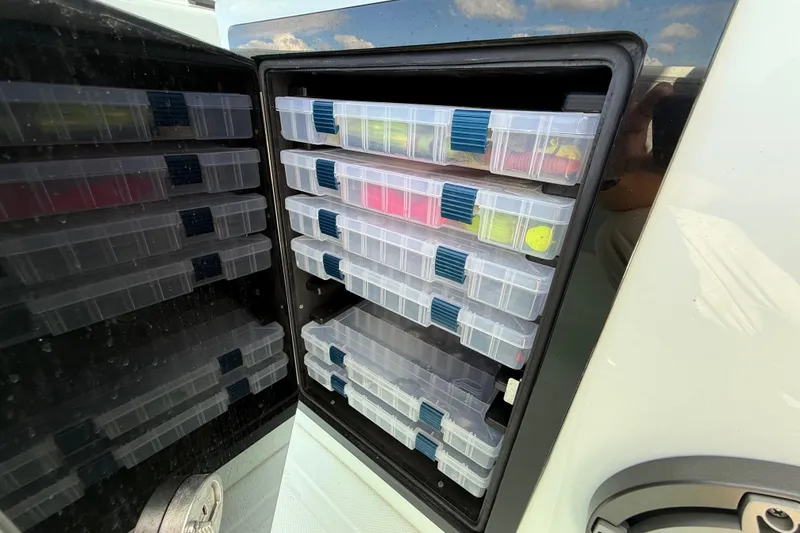 Slide: The Image of Storage compartment with organized tackle boxes on a 2025 Front Runner 37 Catamaran. - 27