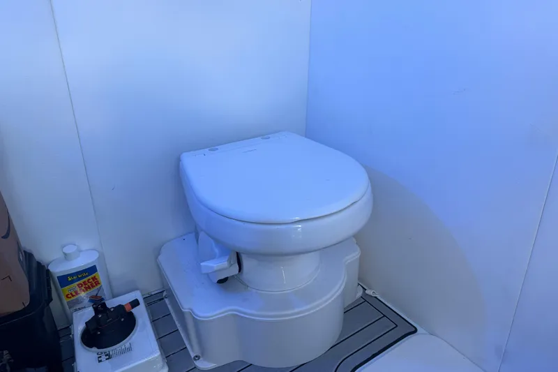 Slide: The Image of Toilet in 2025 Front Runner 37 Catamaran bathroom, with cleaning supplies nearby. - 31