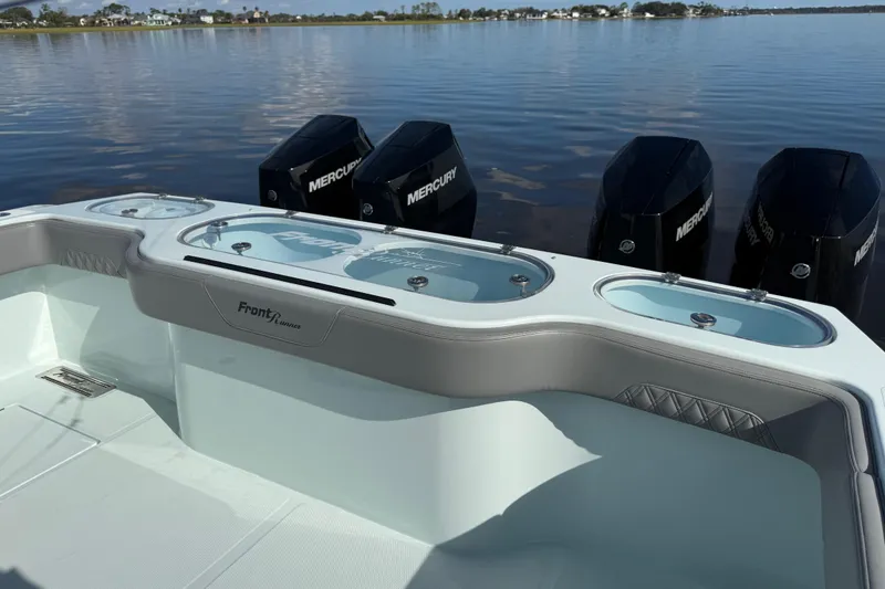 Slide: The Image of 2025 Front Runner 37 Catamaran with Mercury engines on calm water. - 37