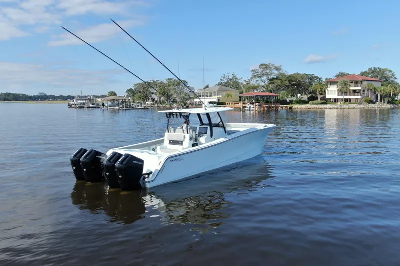 Slide: The Image of 2025 Front Runner 37 Catamaran on calm water near waterfront homes. - 40
