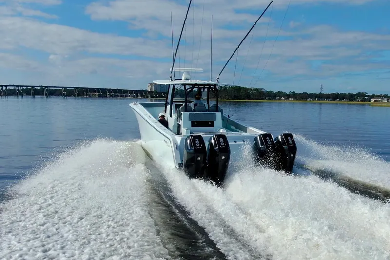 Slide: The Image of 2025 Front Runner 37 Catamaran cruising on water with powerful engines, clear sky backdrop. - 42