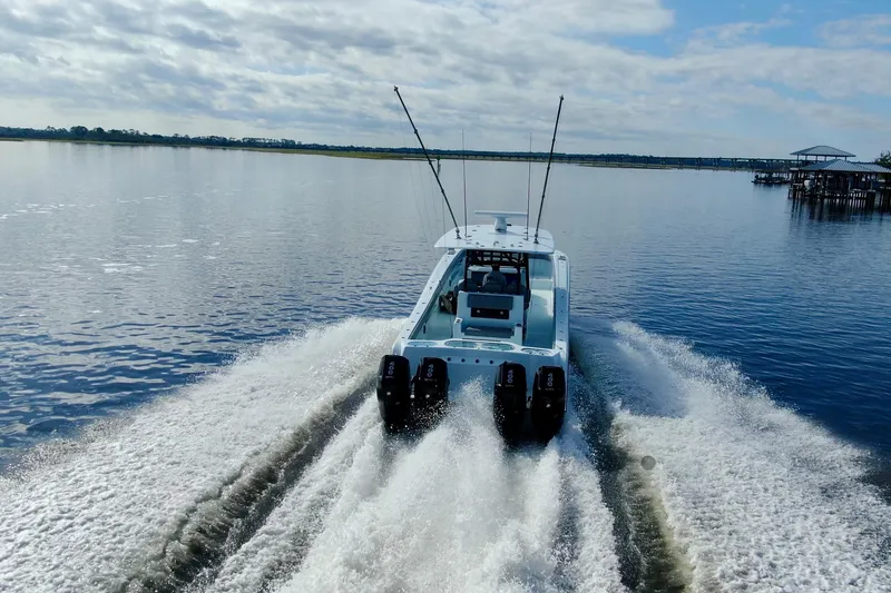 Slide: The Image of 2025 Front Runner 37 Catamaran cruising on a calm lake under a partly cloudy sky. - 45