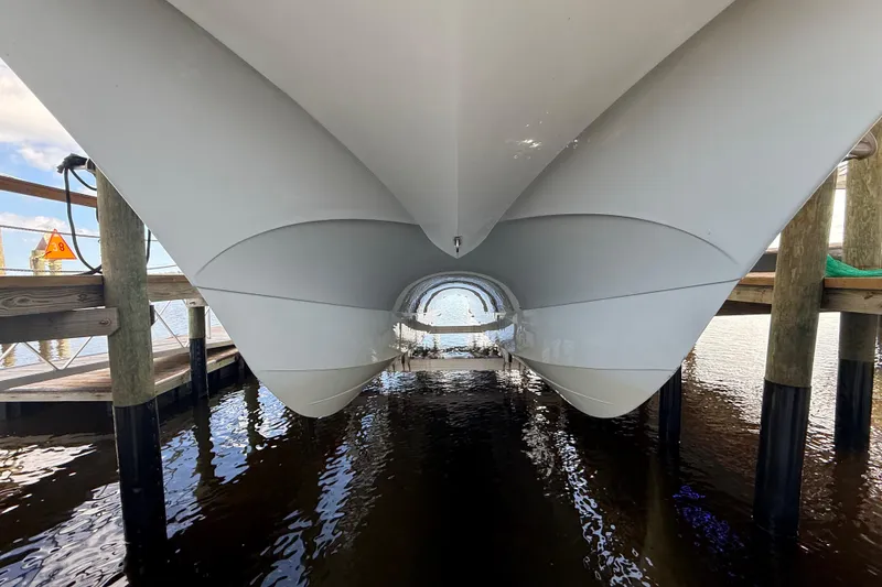 Slide: The Image of Underneath view of 2025 Front Runner 37 Catamaran docked on water. - 48