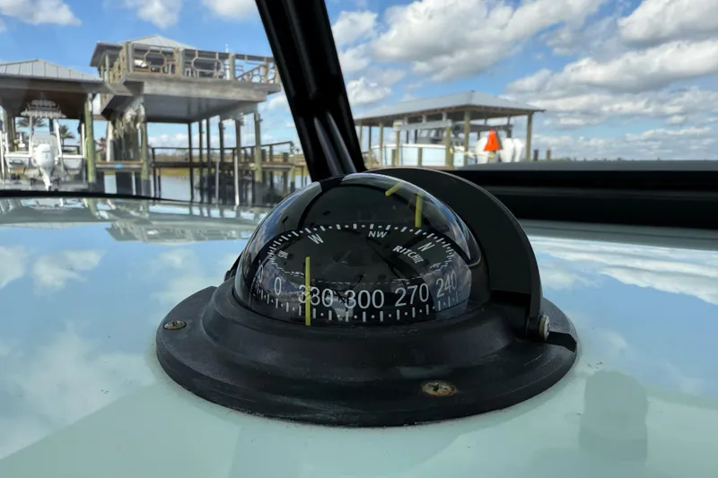 Slide: The Image of Compass on 2025 Front Runner 37 Catamaran, docked under a cloudy sky. - 49