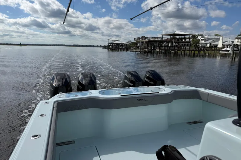 Slide: The Image of 2025 Front Runner 37 Catamaran cruising on a calm river under a partly cloudy sky. - 51